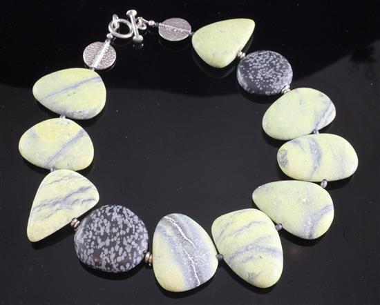 A shaped pebble necklace with two silver medallions and a silver clasp, 20.5in.